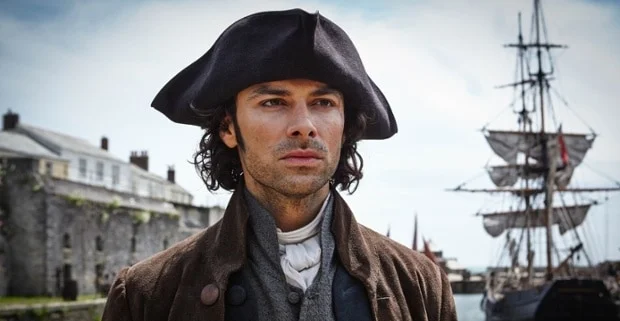 Portrait of a young man wearing a historical tricorn hat and period clothing, set against a backdrop of a coastal town, evoking a sense of 18th-century maritime life.
